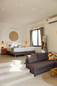 a bedroom with a bed and a couch at Jaya Villas #1 in Uluwatu +53 photos