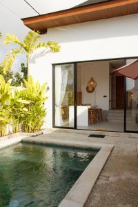 an external view of a house with a swimming pool at Jaya Villas #1 in Uluwatu