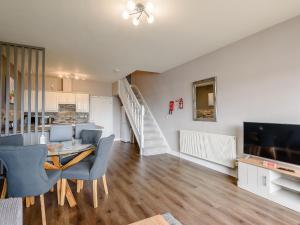 a living room with a dining table and a television at Cottage 7 - Uk38218 in Ashby cum Fenby