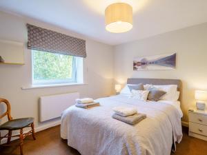 a bedroom with a large bed with towels on it at 1, The Barns in Threlkeld +14 photos
