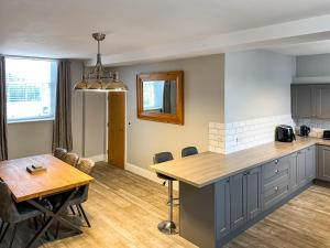 a kitchen and dining room with a table and a dining room at The Old School House in Eggleston