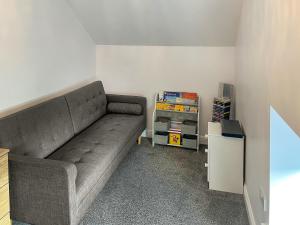 a living room with a couch and a table at The Old School House in Eggleston