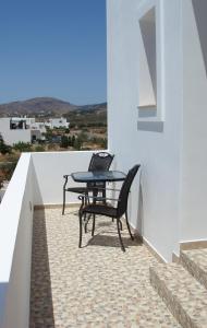 a patio with a table and a laptop on it at Anastasia Studios in Avlemonas
