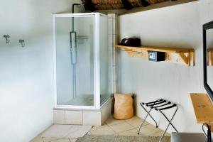 a glass shower in the corner of a room at Riverman Cabin Country Lodge - Tonteldoos in Tonteldoos +169 photos