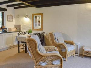 ein Wohnzimmer mit Korbstühlen und einem Tisch in der Unterkunft Ivory Cottage in Woolacombe