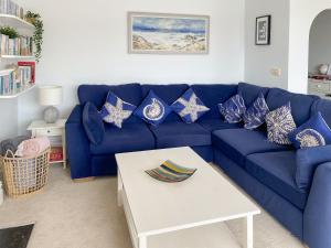 a blue couch with patriotic pillows in a living room at Anchor Loft in Fowey