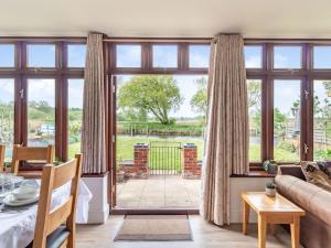 a living room with a large window and a couch at Riversdelle in Beccles +28 photos