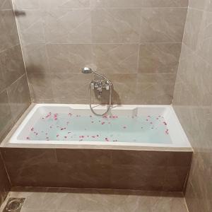 Jāmbにあるvaradan guest houseのスプリンクルが飾られた浴槽のある浴室
