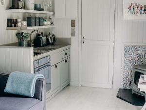 a kitchen with white cabinets and a sink and a stove at Mimi's Meadow-Uk36576 in Milton Abbot