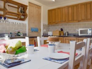 a kitchen with a table with a plate of food on it at The Loft - Uk34070 in Lynton