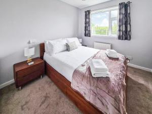 a bedroom with a large bed and a window at Havrock in Kirkwall