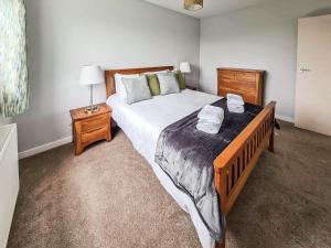 a bedroom with a large bed and a night stand at Havrock in Kirkwall