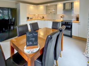 a kitchen with a wooden table with a sign on it at Townhouse - Uk48078 in Kirkwall