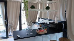 a kitchen with two wine glasses on a counter at Laguna Houseboat in Rome
