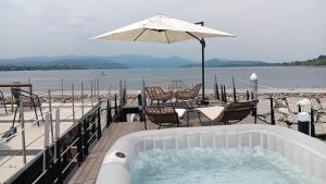 a hot tub with a table and chairs and an umbrella at Laguna Houseboat in Rome +6 photos
