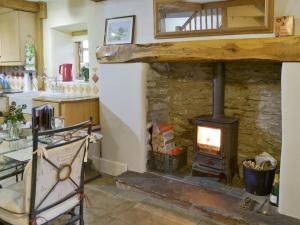 a kitchen with a stone stove in a room at St Francis Cottage in Seathwaite