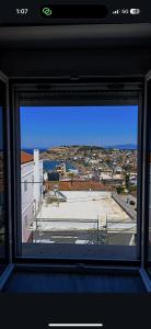 a window with a view of a roof at Castle View Apartment in Mytilini