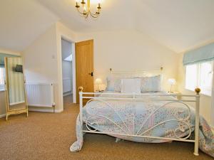 a bedroom with a large bed and a window at Clawdd Offa Barn in Penyffordd