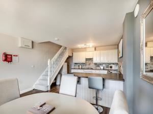 a kitchen and living room with a table and chairs at Cottage 5 - Uk38221 in Ashby cum Fenby