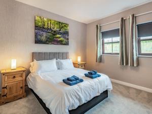 a bedroom with a bed with two towels on it at Cottage 9 - Uk38220 in Ashby cum Fenby +9 photos