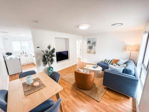 a living room with a blue couch and a table at Halloran 2 in Wagga Wagga