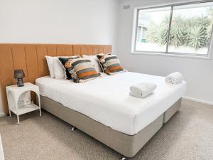 a large bed in a bedroom with a window at Halloran 2 in Wagga Wagga +7 photos