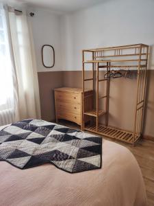 Un dormitorio con una cama con una manta a cuadros. en La maison "Ty Lichoux", en Plouha