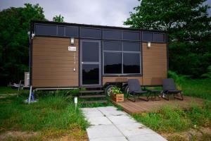 a tiny house with a black roof and windows at Tiny Away Escape at Lazarus - 2017 in Singapore +28 photos