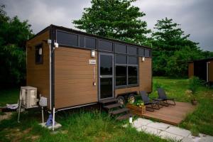 a tiny house sitting on a wooden deck at Tiny Away Escape at Lazarus - 2017 in Singapore