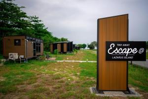 a sign that says my many escape cottages stand at Tiny Away Escape at Lazarus - 2017 in Singapore