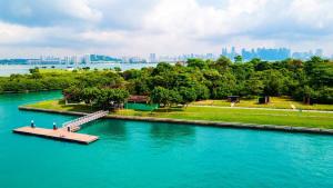 a dock in a river with a city in the background at Tiny Away Escape at Lazarus - 2017 in Singapore