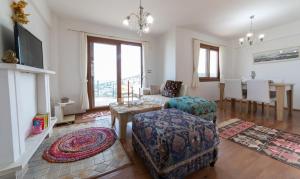 a living room with a couch chair and a table at Villa Selen in Bogazici