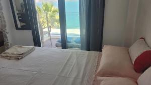 a bedroom with a bed with a view of the ocean at Villa Selen in Bogazici +64 photos