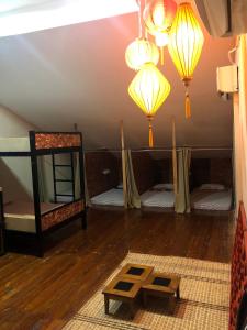 a room with four bunk beds and lights on the ceiling at 24 Seven Heritage Hostel in Kuching