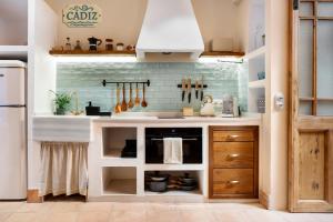 a kitchen with a sink and a stove at Mi Andalusia Hotel Experience in Málaga