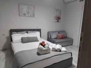 a bedroom with a large bed and a chair at Our No1 apartment Paralia in Paralia Katerinis