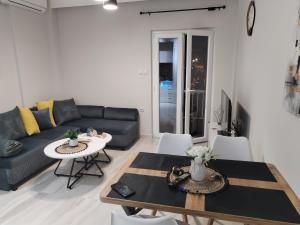 a living room with a couch and a table at Our No1 apartment Paralia in Paralia Katerinis