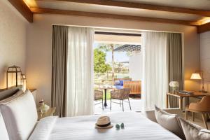 a hotel room with a bed and a dining room at Jumeirah Al Naseem Dubai in Dubai