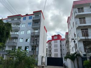 a group of tall buildings in a city at Comfy Apartments in Mombasa