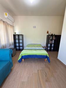 a bedroom with a bed and a couch in it at Casa Pax - Hab El Rincón del Pescador Frente al Mar in La Paz