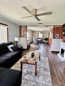 a living room with a couch and a table at Spacious Lake Retreat for Families in Saint Cloud +53 photos