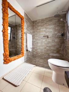 a bathroom with a shower and a toilet and a mirror at Villa Amalia - 3 bedroom & bathroom villa with a private pool in Santa Maria