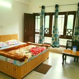 a bedroom with a large bed with flowers on it at The Velvet Pine in Chamba +14 photos