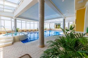a pool in a building with a large room at Hotel Savoy in Opatija