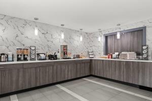 a restaurant with a counter and a counter at Baymont by Wyndham Batavia - Darien Lake in Batavia