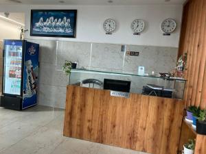 a restaurant with clocks on the wall and a counter at Hotel Moon Regency I Couple and Corporate Friendly I Panipat in Pānīpat
