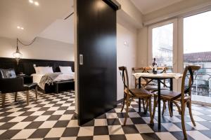 a room with a table and chairs and a bed at Apart Hotel B in Santiago