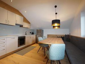 a kitchen with a table and chairs in a room at Holiday apartment for 5 people in Ried im Zillertal +13 photos