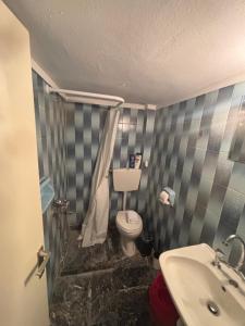 a bathroom with a toilet and a sink at Summer Holidays in Nea Kalikratia