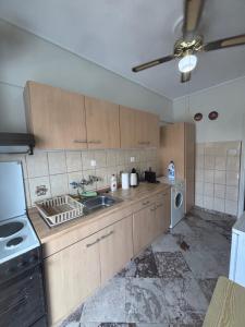 a kitchen with a sink and a stove at Summer Holidays in Nea Kalikratia
